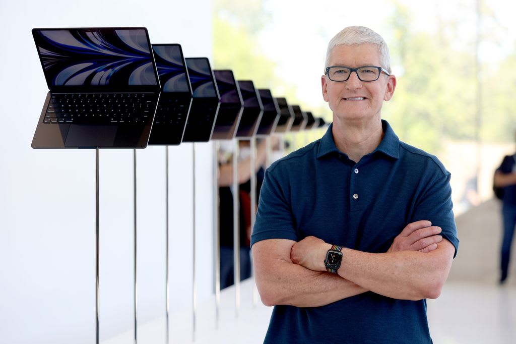 Tim Cook in front of display of Macbook Air laptoops