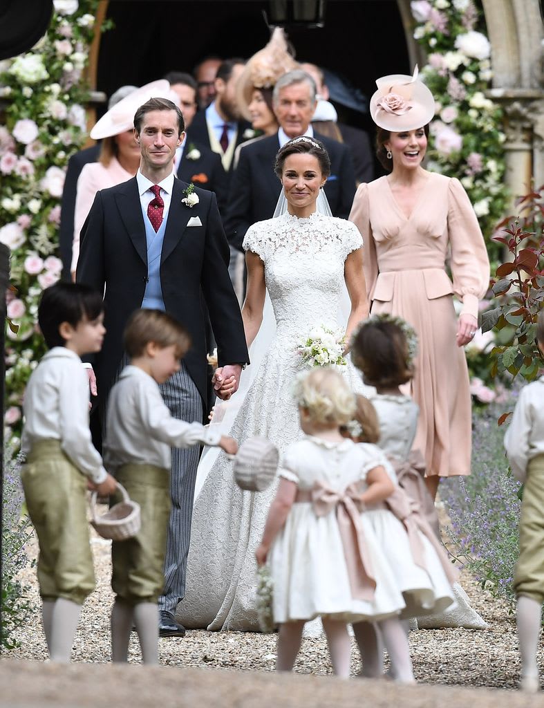 Kate beams behind the newlyweds