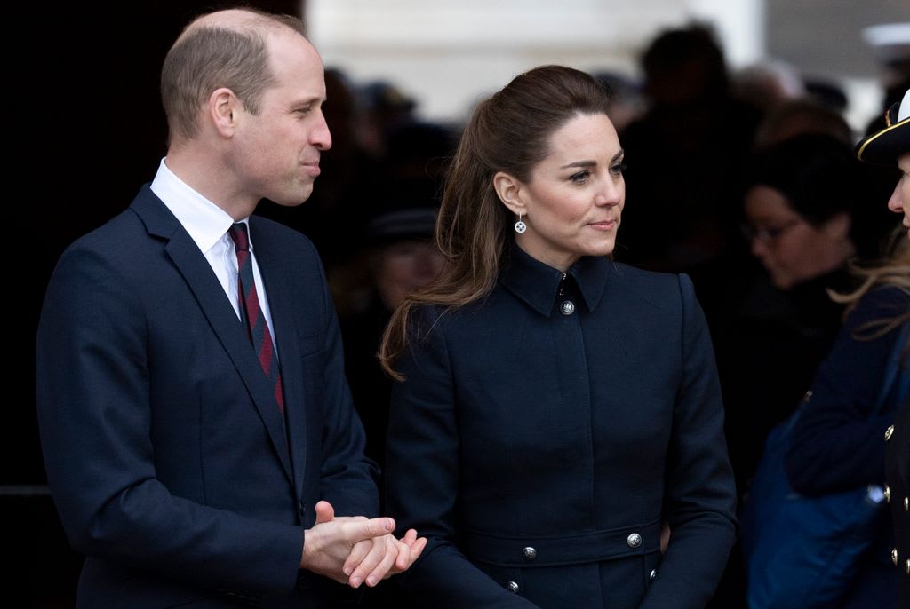 william clasping hands and kate middleton in a black coat