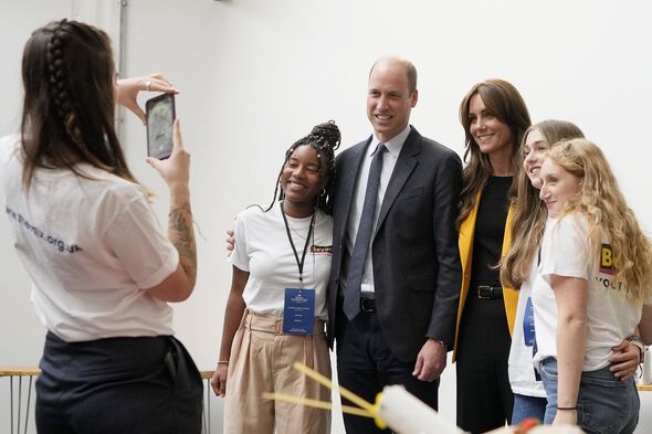 Kate and William pose for photo with young people
