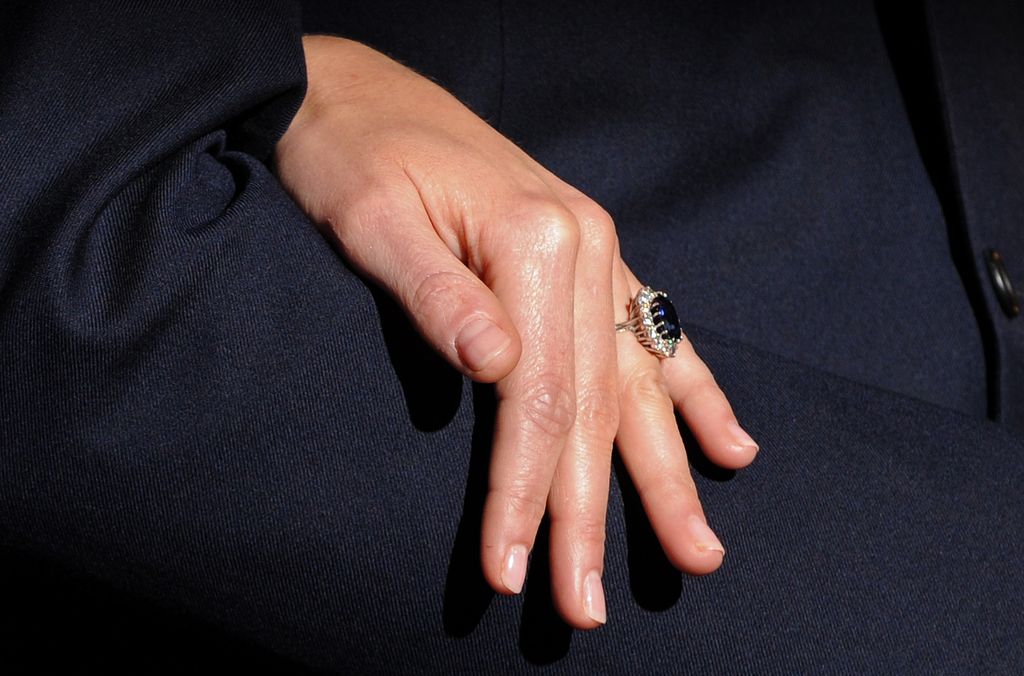 Kate Middleton shows off her engagement ring as they pose for photographers during a photocall to mark their engagement