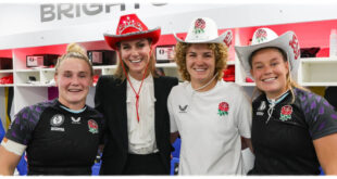 Princess Kate wearing a red cowboy hat with bejeweled crown detail at a rugby match, breaking royal fashion protocol