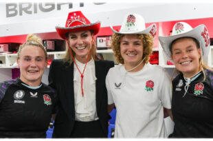 Princess Kate wearing a red cowboy hat with bejeweled crown detail at a rugby match, breaking royal fashion protocol