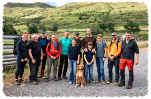 Prince William and Princess Kate posing with Prince George, Princess Charlotte, Prince Louis and mountain rescue volunteers in a previously unseen family photograph