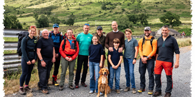 Prince William and Princess Kate posing with Prince George, Princess Charlotte, Prince Louis and mountain rescue volunteers in a previously unseen family photograph